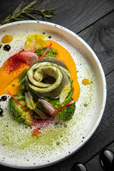 Sea fish cooked in a premium restaurant, with sauce and vegetable puree on a white trail
