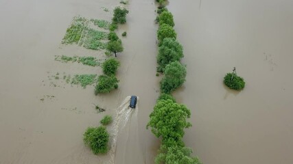 Aerial view flooded road heavy rain flooding taken during drone flight overflowing river storm water, danger wet disaster damage grass, climate lake high stream season environmental ecology rural
