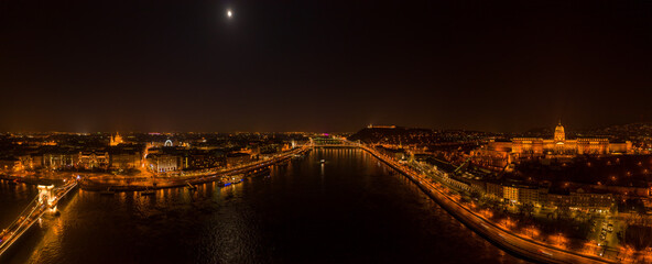 Panoramic aerial drone shot of Danube with moon National Gallery and chain bridge in Budapest night