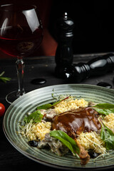 Duck legs confit with potato gratin and mushroom sauce. Restaurant serving. Copy space. Top view