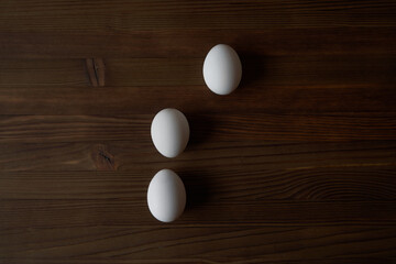 Eggs on a wooden table. View from above.