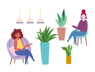 women sitting on chairs potted plants and lamps decoration