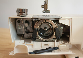 Details of the bottom of an electric sewing machine. cleaning the sewing machine.
