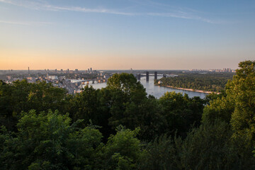 The sun sets on the Dnieper River and Kiev, Ukraine on a beautiful summer evening.