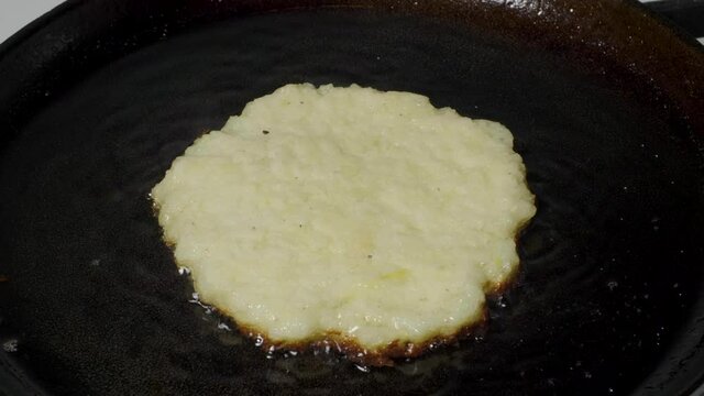 Traditional Belarussian potato pancakes draniki are fried in vegetable oil in a pan