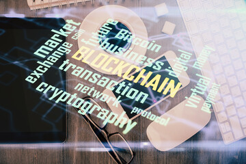 Double exposure of blockchain theme hologram over table with phone. Top view. Crypto technology...