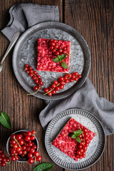Sweet red currant dessert filled with cream cheese, decorated with fresh berries