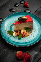 Napoleon cake with strawberries and ice cream on a round plate