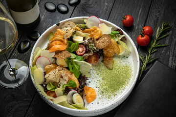 meat salad with vegetables, tomatoes, carrots on a white plate
