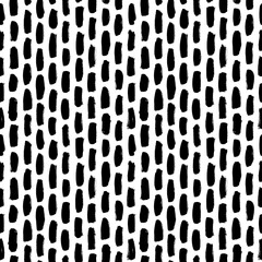 Vertical brush strokes vector seamless pattern. Black paint scribbles, dash lines, dry brushstroke texture. Regular rough smears. Black and white monochrome texture. Hand drawn grunge ink shapes.