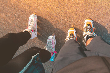 Top view of legs with inline skates. Boy and girl on roller skates. Place for text.