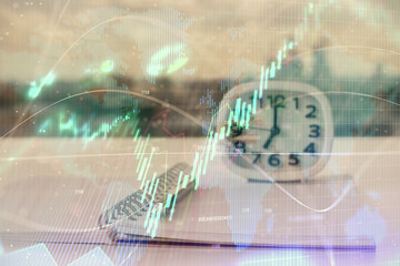 Double exposure of financial graph drawings and desk with open notebook background. Concept of forex market