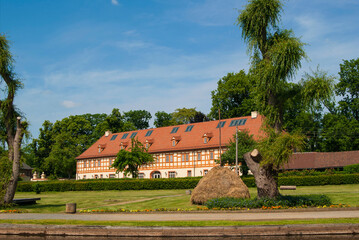 House of traditional architecture in the city Lübbenau/ Spreewald, Germany. In front of him is a grass lawn and green trees.