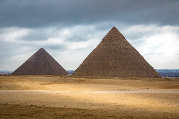 Obraz na płótnie Canvas Giza pyramids, under cloudy sky near Cairo, Egypt