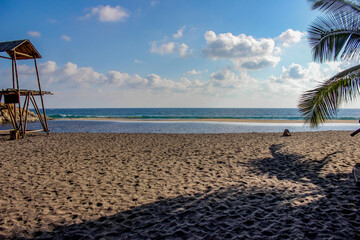 Lagoon that converges with the beach in Ventanilla Oaxaca, beach sand, lookout of a life saver.