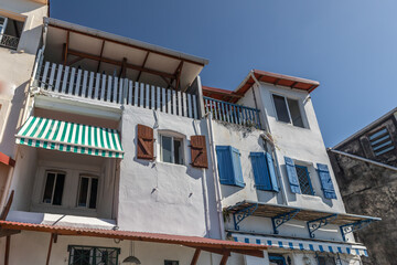 Building with brown and blue shutters in Saint-Pierre, Martinique, France