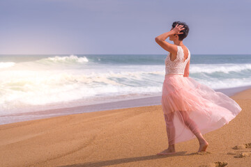 Fototapeta na wymiar Romantic young girl on the beach. Beautiful model. Soft background