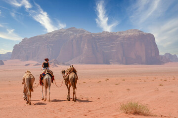 Female tourist riding a camel in the Wadi Rum desert
