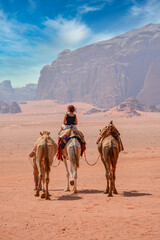 Female tourist riding a camel in the Wadi Rum desert
