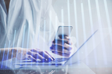 Double exposure of financial graph sketch hologram and woman holding and using a mobile device. Stock exchange concept.