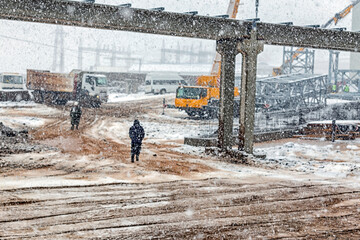 Landscape of the construction site while it snows.