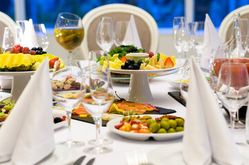 cheese plate with grapes on a table in a restaurant, cold snacks at a reception