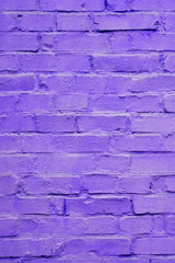 brick wall painted in violet lilac color shot perpendicularly close up
