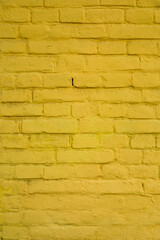 yellow painted brick wall shot in closeup as an invoice for decoration