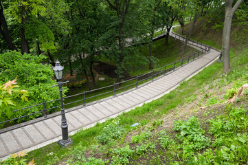 Fototapeta na wymiar landscaped stone steps in a pedestrian park with metal railings
