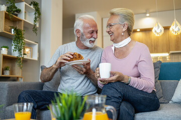 Senior couple having breakfast at home.