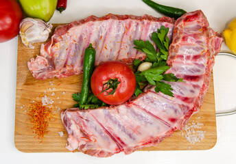raw pork ribs on a wooden board