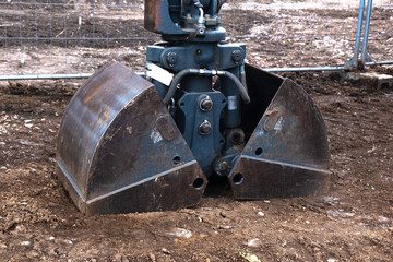 excavator bucket cover or bucket stuck in the ground. Part, spare part from construction equipment. Building
