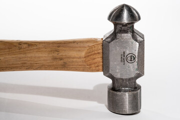 Close-up of the head of a Ball Peen hammer isolated on a white background
