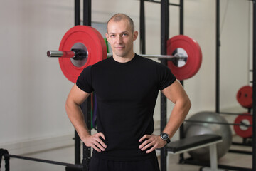 Fototapeta na wymiar Portrait Of Personal Trainer In Fitness Centar Gym