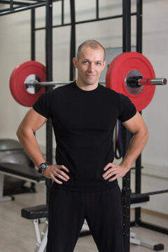 Muscular Man In Sports Outfit In Fitness Center