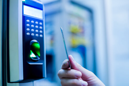 Door access control. Staff holding a key card to lock and unlock door at control room or data center. The concept of data security or data access control.