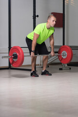 Couch Exercising Back With Barbell In Gym