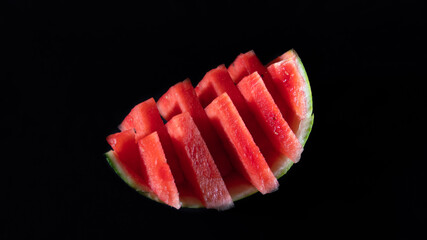Close-up on a piece of watermelon, the slices of which are arranged in alternating triangles