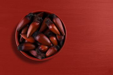 Pinion, traditional Brazilian food, Araucaria seed. Top view on colorful wooden background