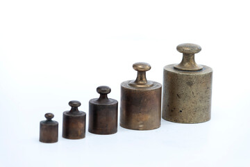 
set of old bronze balance weights with white background