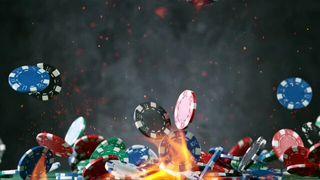 Poker chips with fire flames falling on casino table in super slow motion, filmed on high speed cinema camera at 1000 fps. Gambling background.