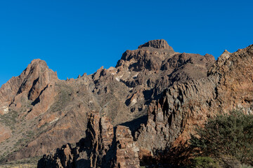 Brown volcanic stone mountain with blue sky on the teide on the island of tenerife in spain