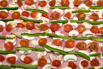 Home made pizza with ham, tomato, pepper and mushroom
