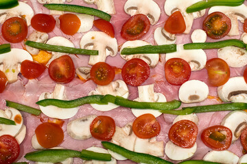 Home made pizza with ham, tomato, pepper and mushroom
