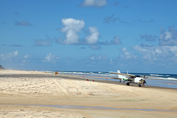 Fototapeta na wymiar Beautiful image of Fraser Island along 75 miles beach showing blue sky, sand, water and waves