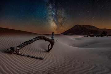 dreamy landscape with milky way and stars over Corralejo sand dunes, Fuerteventura, Spain.