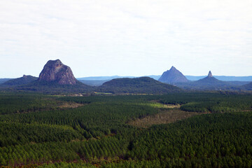 Glass House Mountains, Sunshine Coast, Queensland, Australia showing blue sky, mountains, paddocks, farming land and forests