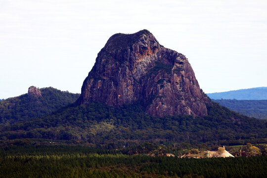 Glass House Mountains, Sunshine Coast, Queensland, Australia showing blue sky, mountains, paddocks, farming land and forests