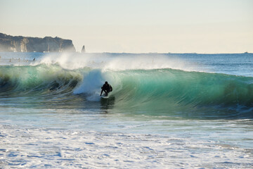 Surfer on Blue Ocean Wave riding on surfing board in Asia.  Japan is famous for its great waves...