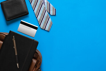 Top view of wallet, credit or debit card, tie, and notebook. Businessman concept.
